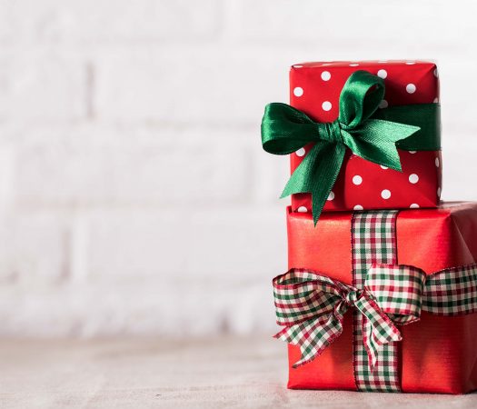 Wrapped Low FODMAP Presents by a white brick wall