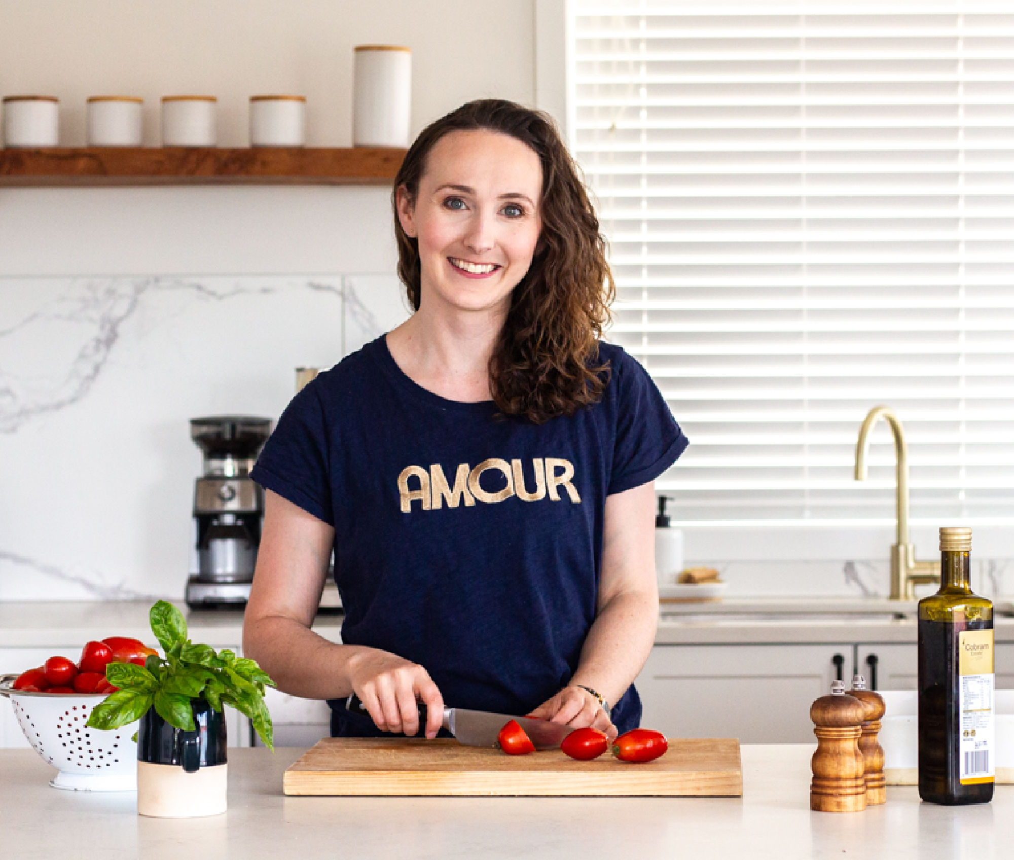 Alana Founder of A Little Bit Yummy Chopping Tomatoes